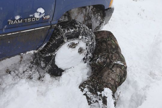 Ron had the chore of chaining up the truck every morning to get Brad into the backcountry.